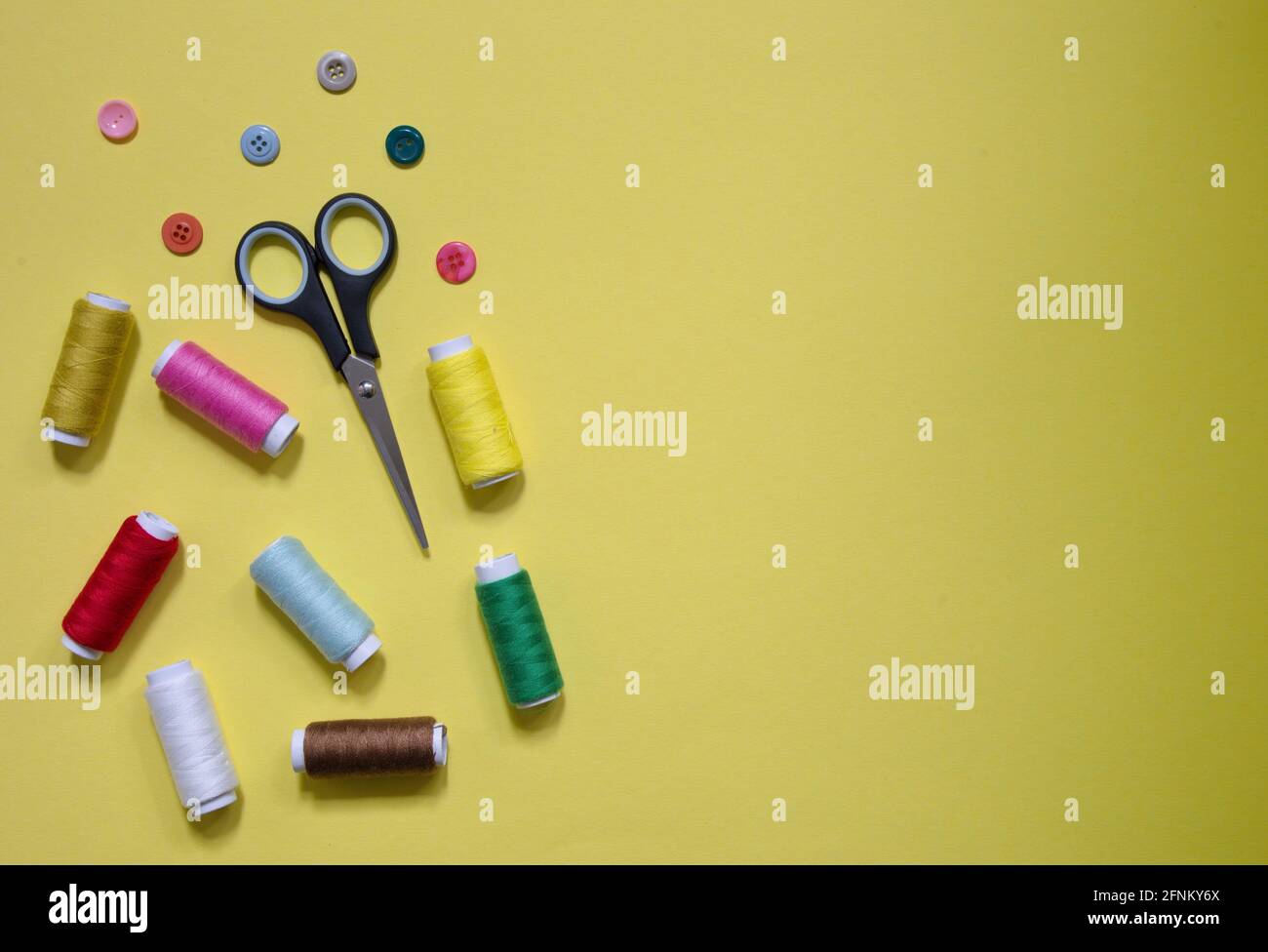 High angle view of sewing items on yellow background Stock Photo
