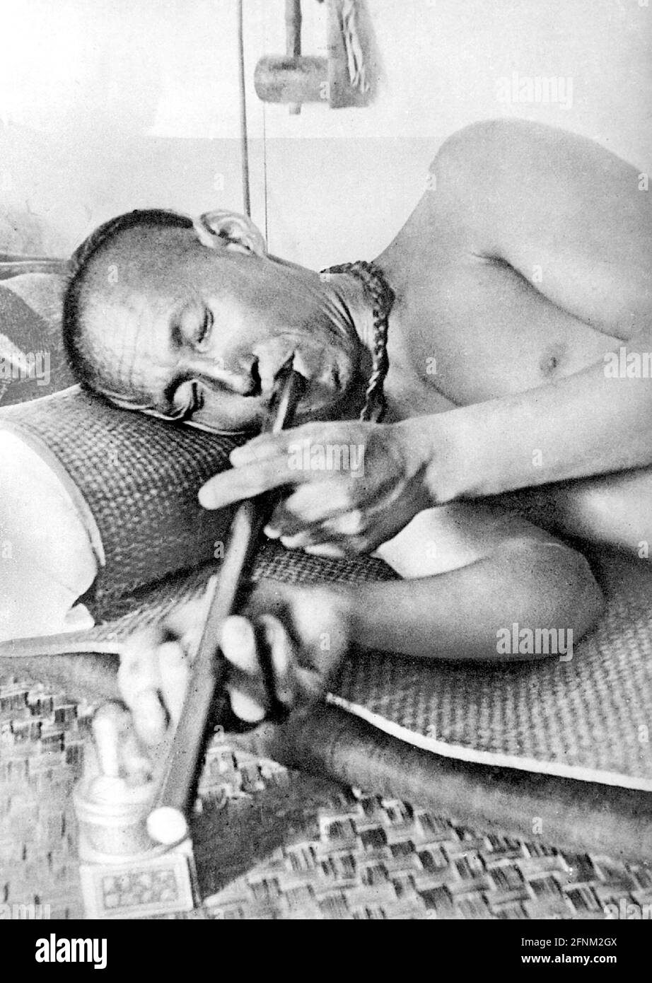 drugs and dope, opium, man smoking opium pipe, 20th century, historic, historical, narcotic drug, ADDITIONAL-RIGHTS-CLEARANCE-INFO-NOT-AVAILABLE Stock Photo