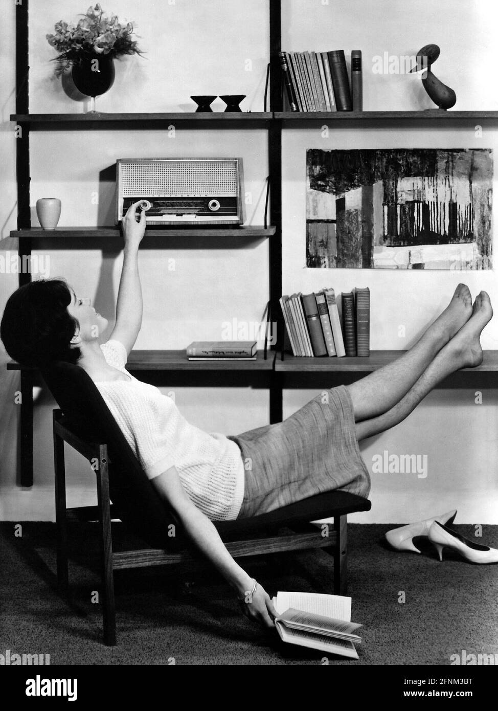 broadcast, radio, woman sitting in living-room and listening to the radio, circa 1960, ADDITIONAL-RIGHTS-CLEARANCE-INFO-NOT-AVAILABLE Stock Photo