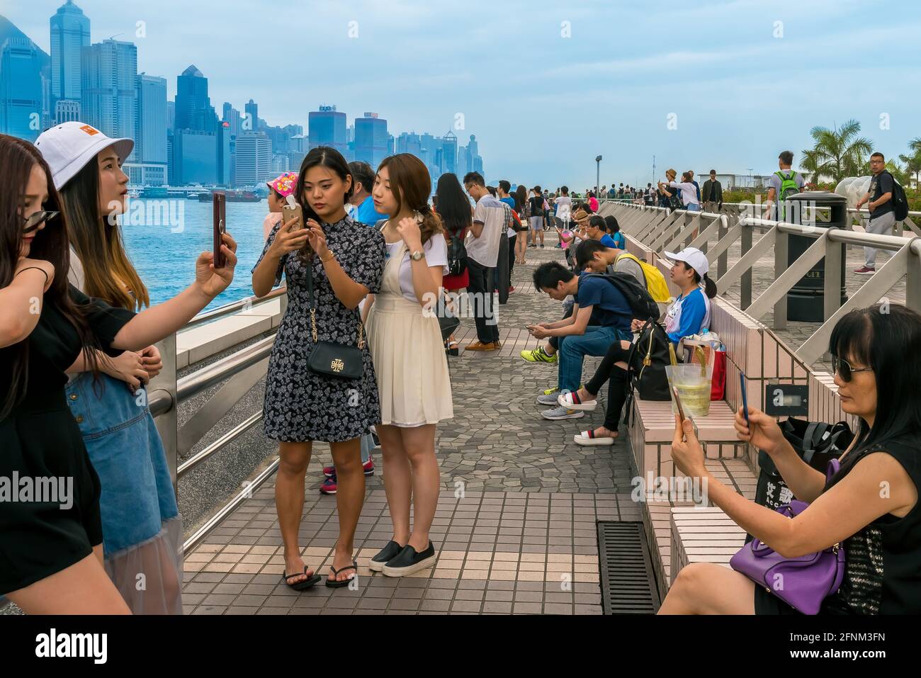 Selfie City in Hong Kong.  Everyone is taking a selfie while an amazing backdrop awaits. Stock Photo