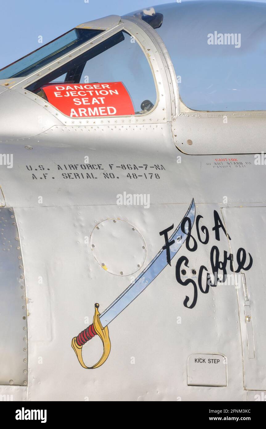 North American F-86A Sabre at Duxford, UK. United States Air Force 1950s fighter jet plane with Danger ejection seat armed warning sign. Cutlass art Stock Photo