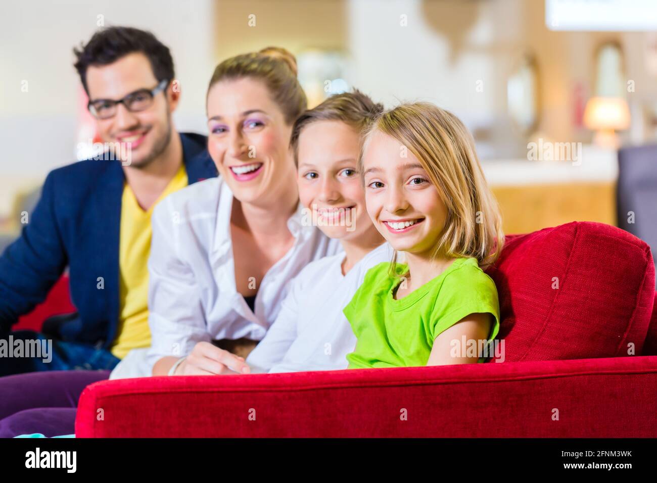 Family selecting together sofa in home-centre to furniture store Stock Photo