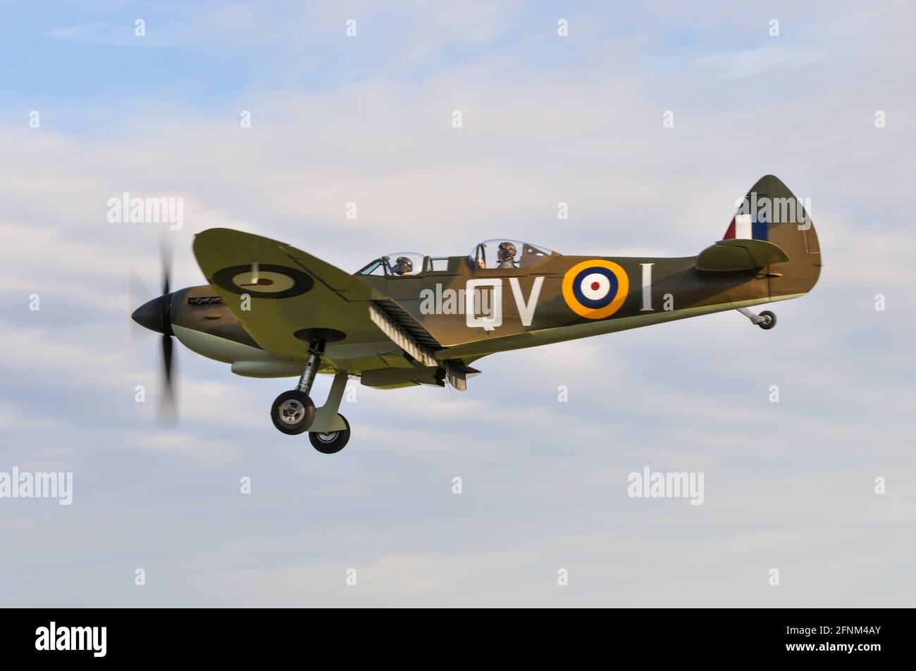 Two seat Second World War Supermarine Spitfire fighter plane with passenger. TR.9 PV202 (G-CCCA) fighter plane. Converted Spitfire for training pilots Stock Photo