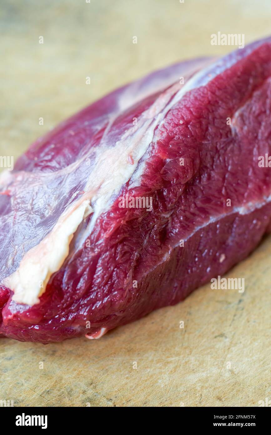 Raw beef tendon meat close-up on cutting board Stock Photo - Alamy