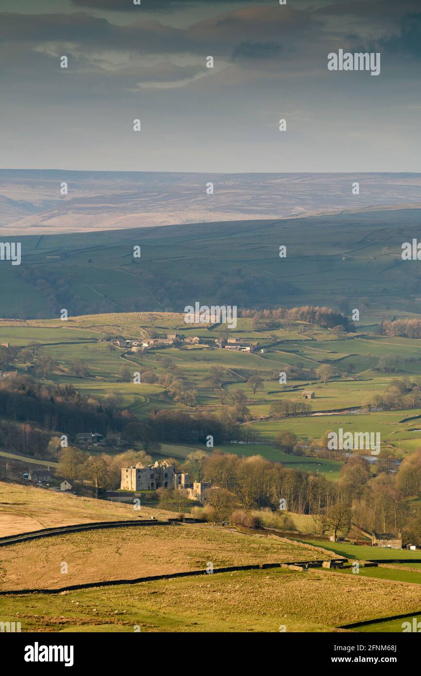 Scenic rural view of Wharfedale (wide green valley, rolling hills, high upland fells & moors, sunlit Barden Tower ruins) - Yorkshire Dales England, UK Stock Photo