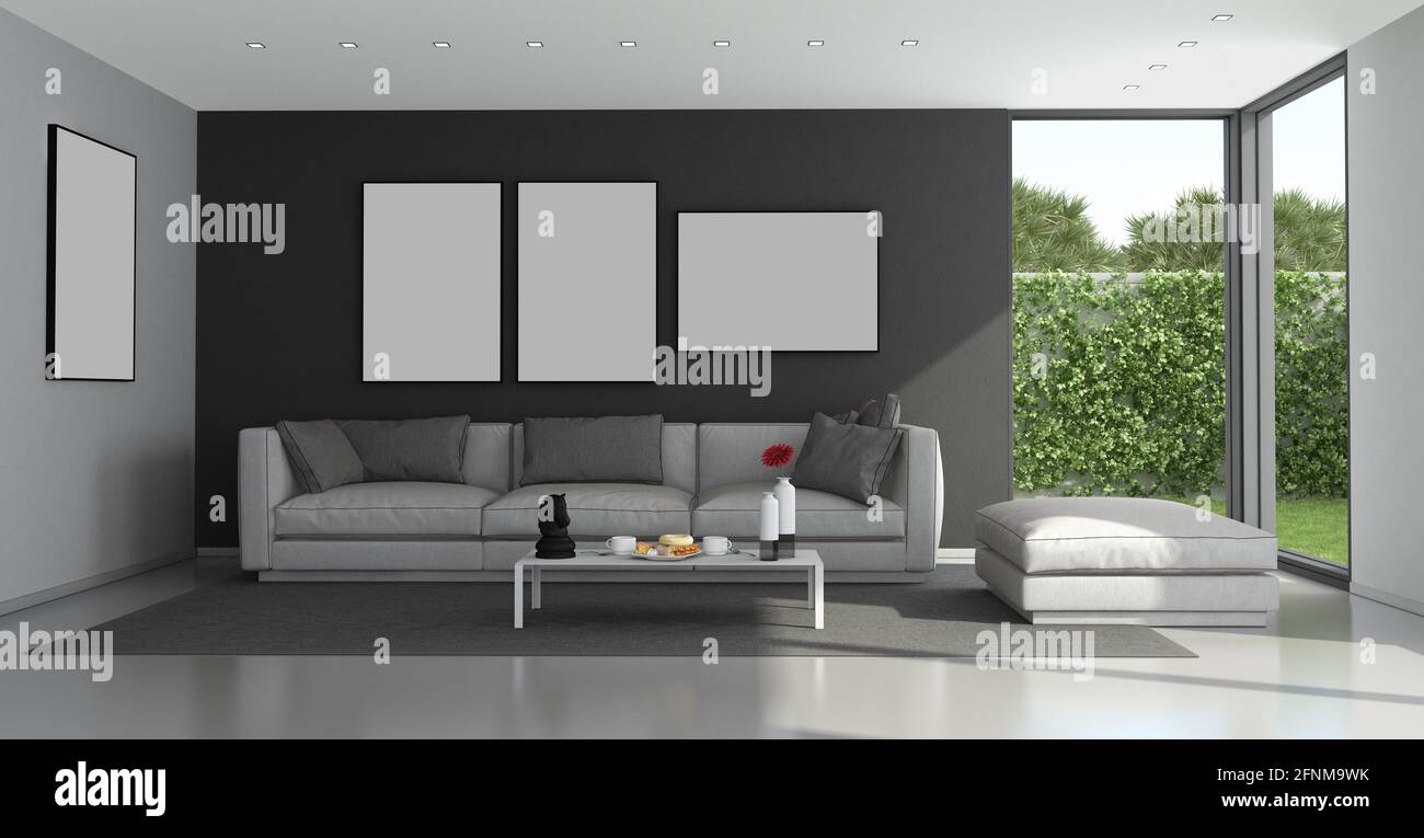 Black and gray modern living room with large windows and garden on