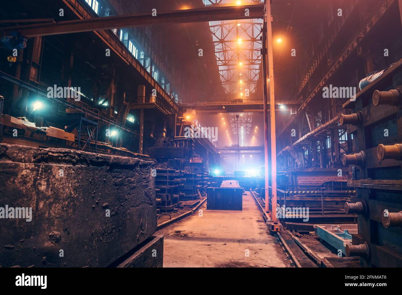 Factory interior. Heavy metallurgy industry. Foundry workshop. Steel Mill industrial plant. Metal manufacture. Large industrial building inside with metalwork equipment. Stock Photo