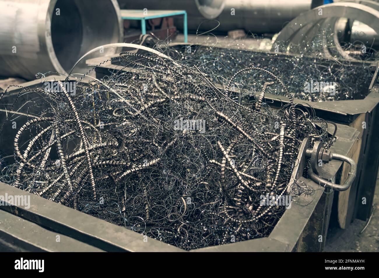 Metal shavings or scrap metal waste steel for recycling in container in factory. Stock Photo