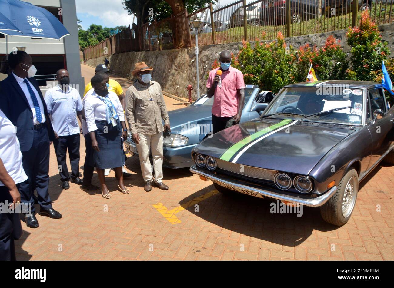 Kampala, Uganda. 17th May, 2021. Visitors look at cars during a vintage