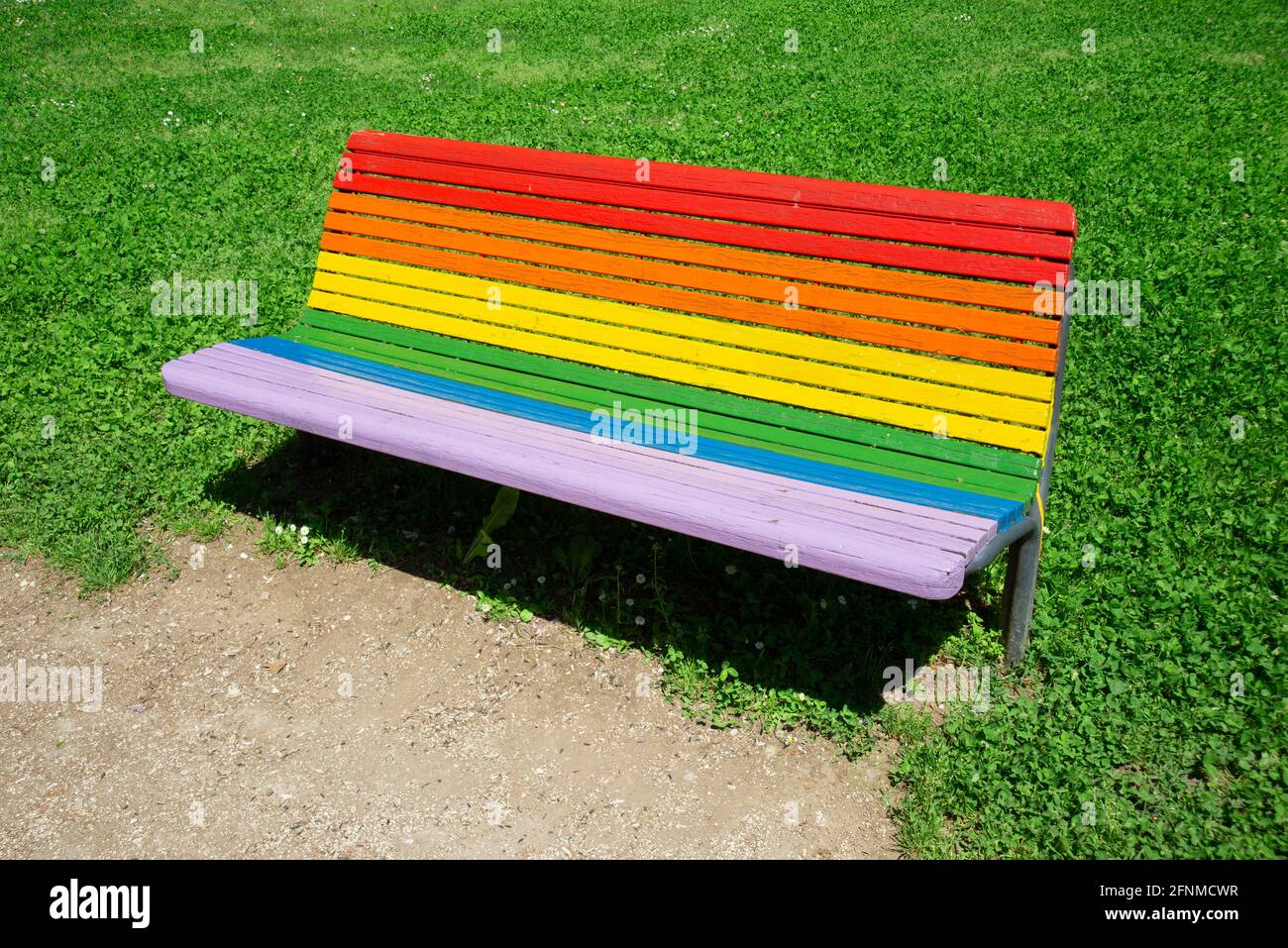 Bench Painted in Rainbow Colors in the Park Stock Photo