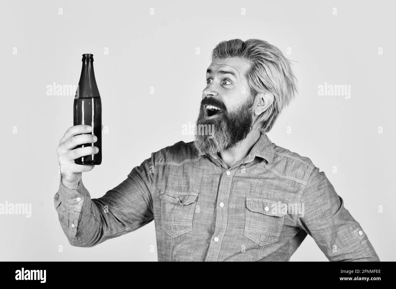 clear pour water in bottle. Party with friends. Brutal bearded man drink beer from bottle. Friends leisure lifestyle concept. stylish handsome man Stock Photo