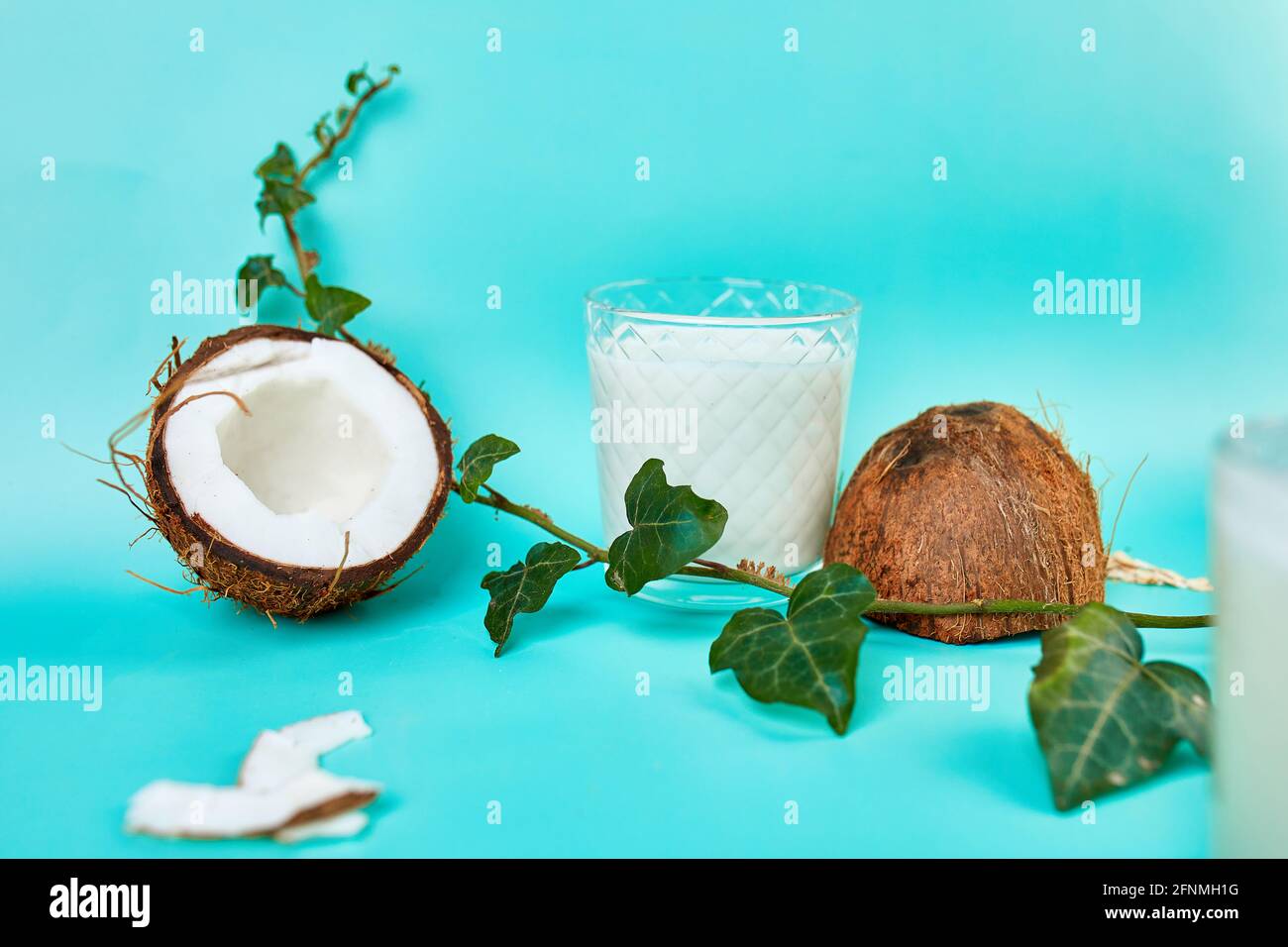 Fresh healthy coconut milk in a glass on blue  background, Alternative type of vegan milks, Organic Healthy drink concept. Stock Photo