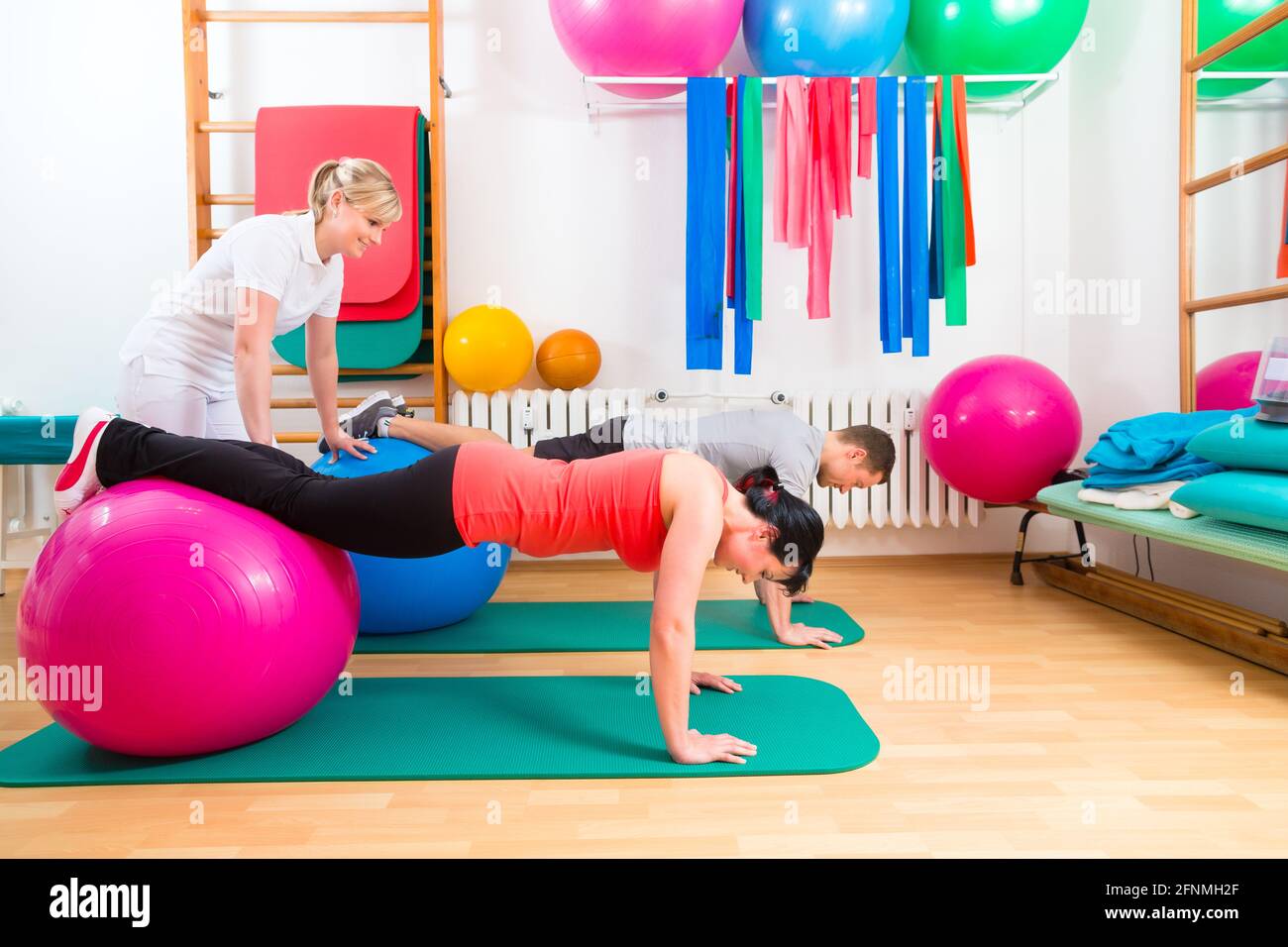 Patient Exercise Patients at the physiotherapy doing physical exercises with therapist ...