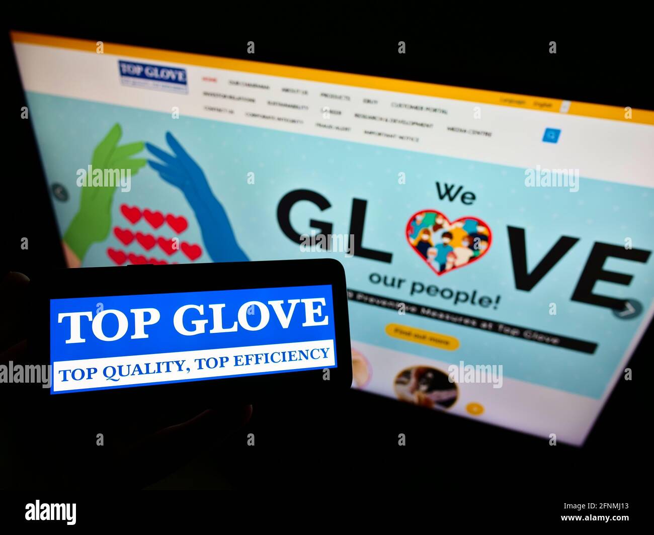 Person Holding Smartphone With Logo Of Malaysian Company Top Glove Corporation Berhad On Screen In Front Of Website Focus On Phone Display Stock Photo Alamy