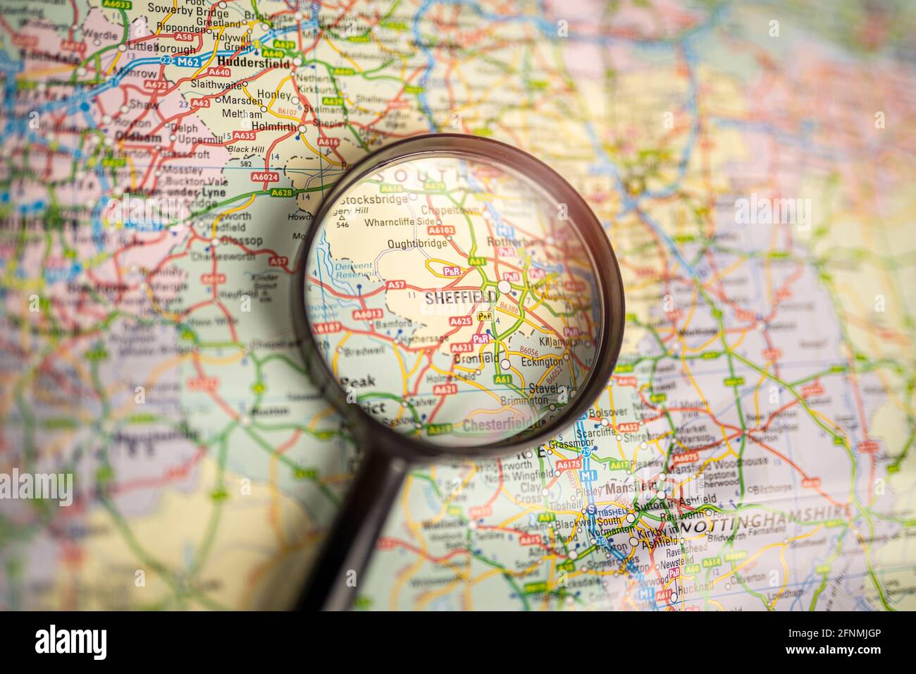 Close-up map of Sheffield through black magnifying glass, city in England, United Kingdom Stock Photo