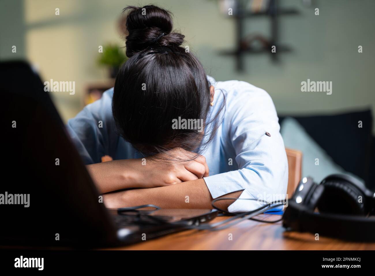 young Business woman sleeping by closing laptop while working, concept of new normal burnout, over or late night work at home during coronavirus covid Stock Photo