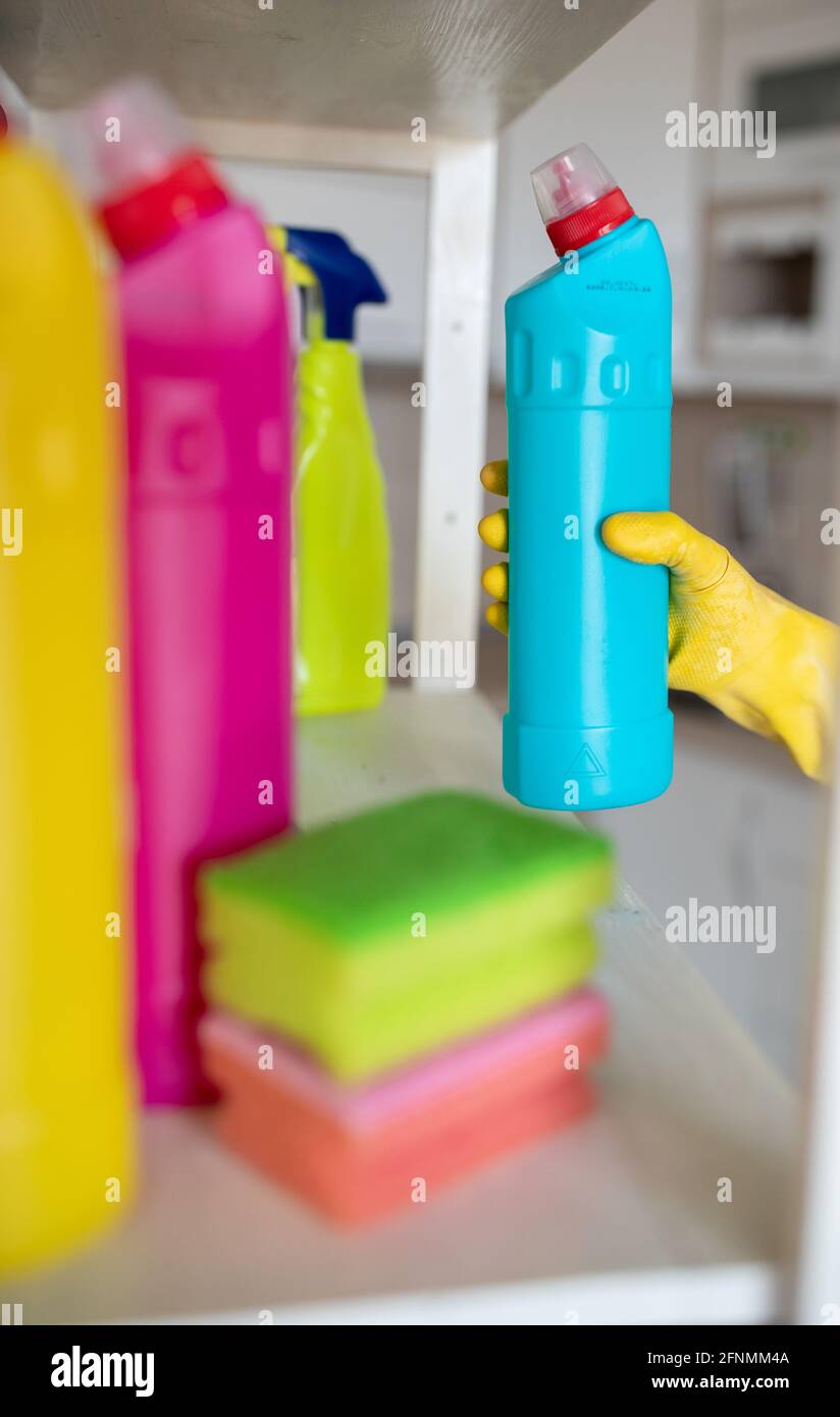 https://c8.alamy.com/comp/2FNMM4A/close-up-of-female-hand-with-protective-gloves-taking-bottle-with-cleaning-products-from-shelf-2FNMM4A.jpg