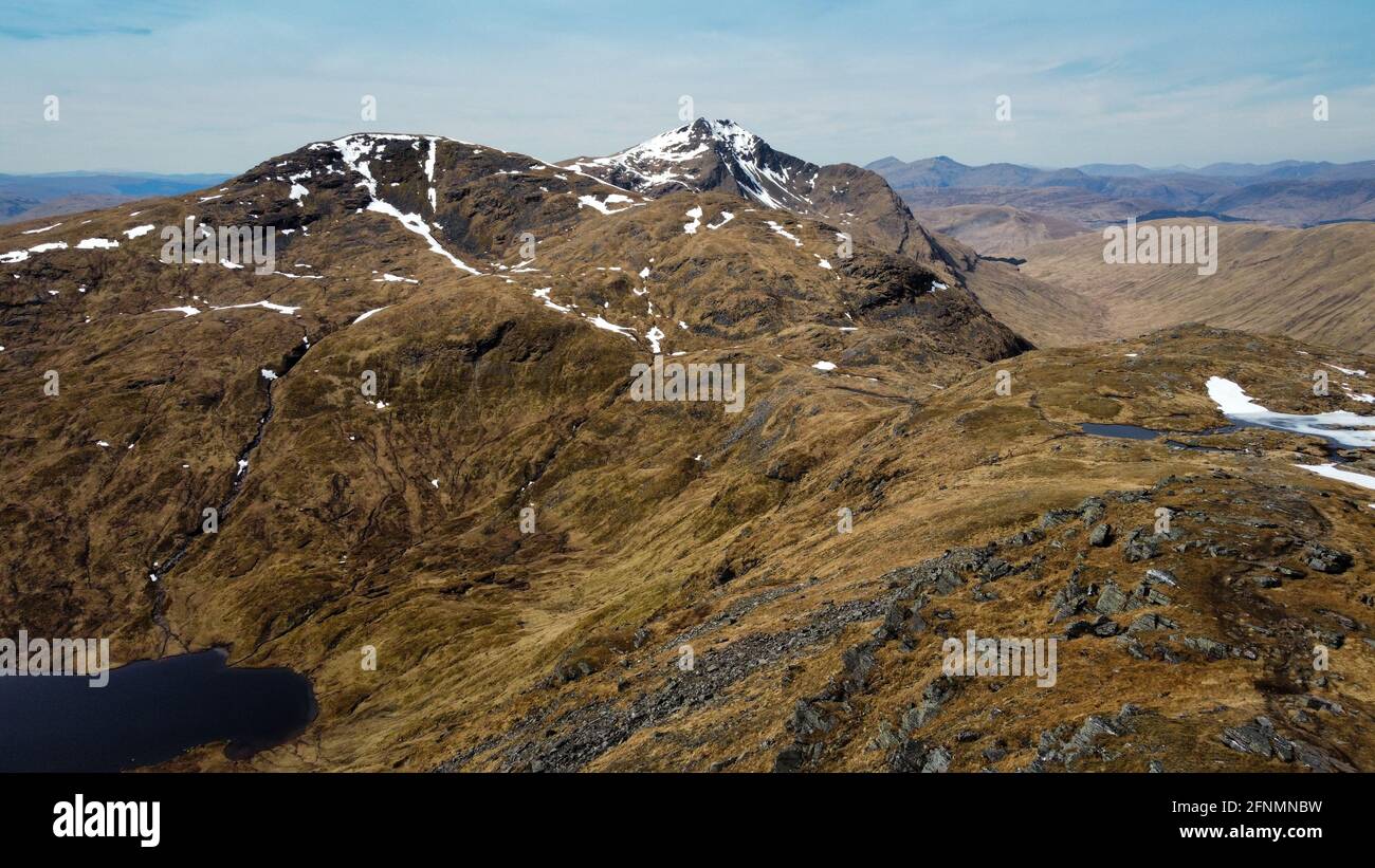 Ben Oss, a Munro just north of Loch Lomond, as seen from above Ben Dubhchraig. This amazing mountainous scene captures the beauty of Scottish hills. Stock Photo
