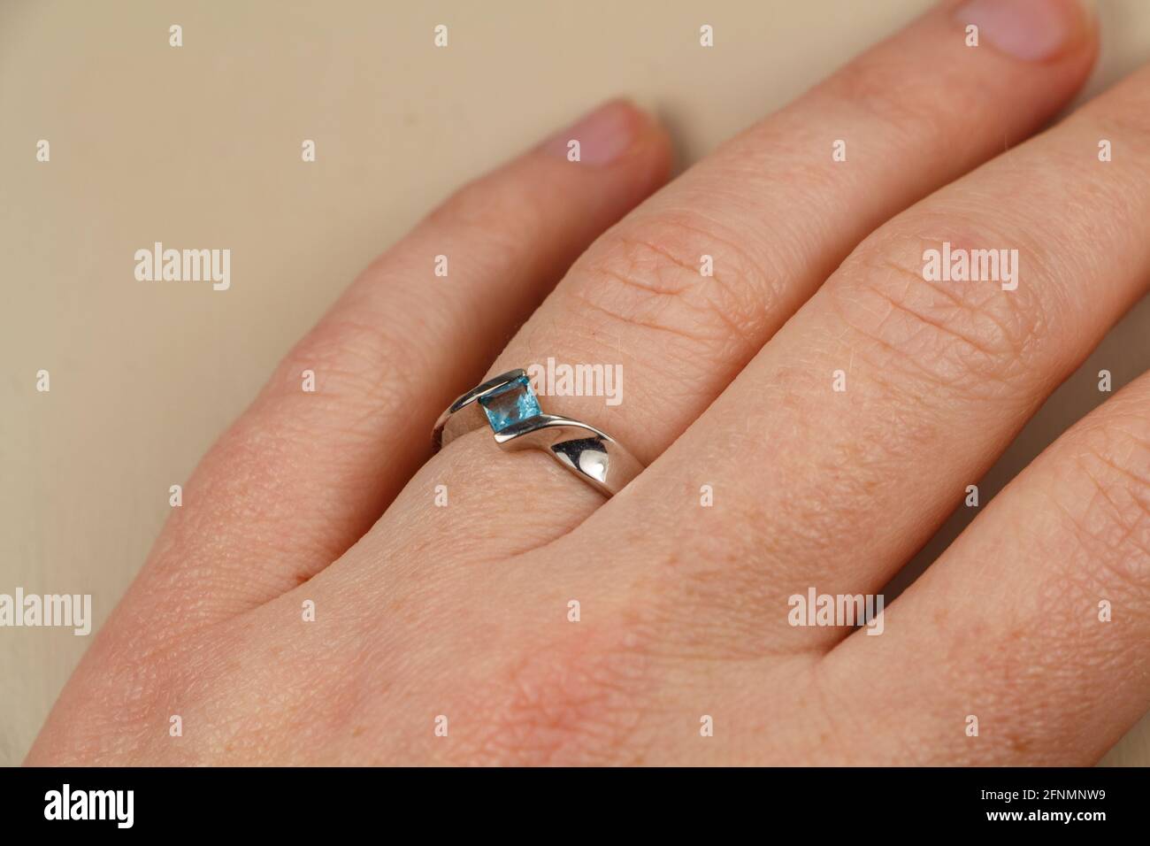 Ring with aquamarine on the hand of a woman Stock Photo
