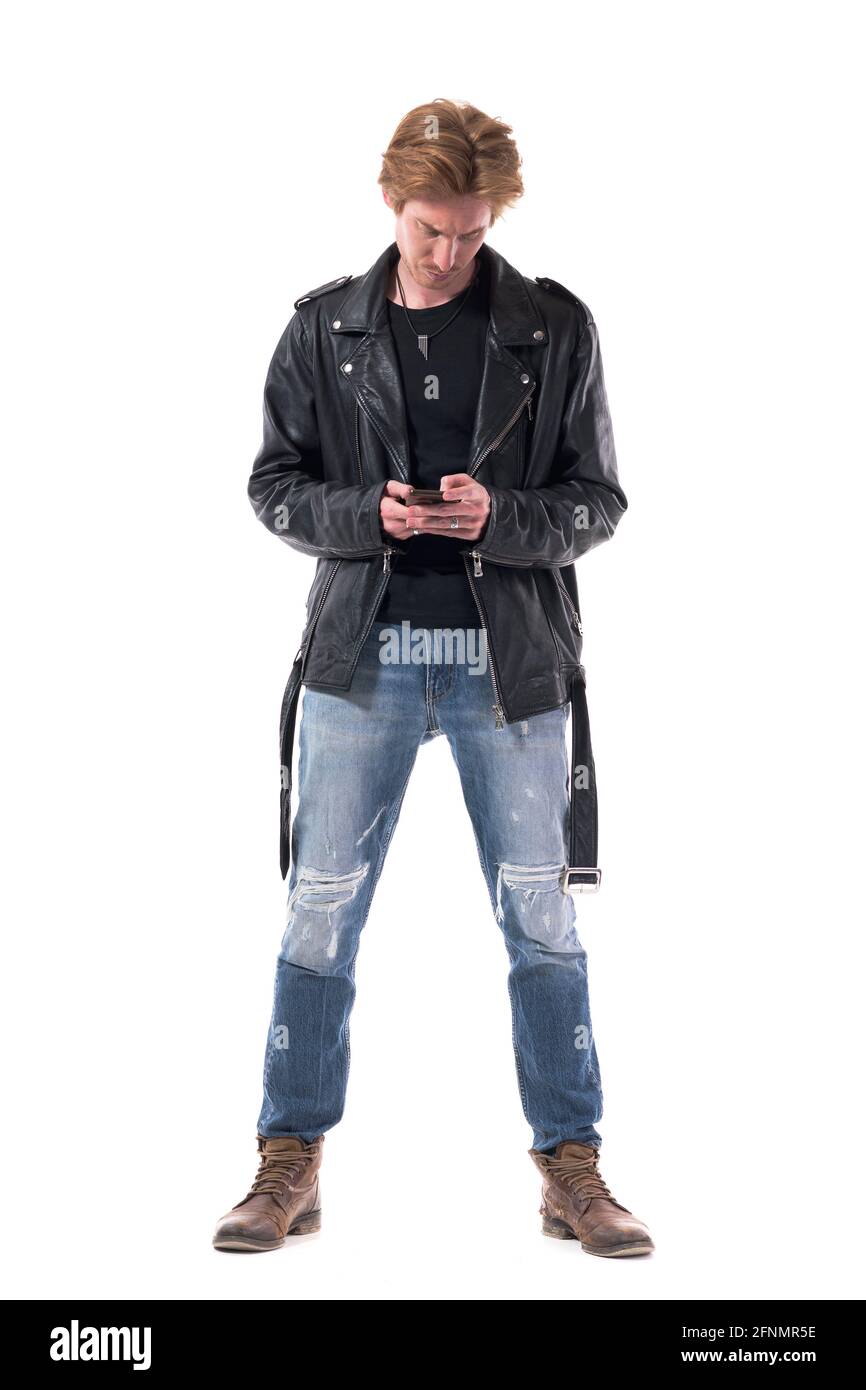 Displeased rocker style clothes young adult man using phone with frowning  expression. Full body length isolated on white background Stock Photo -  Alamy