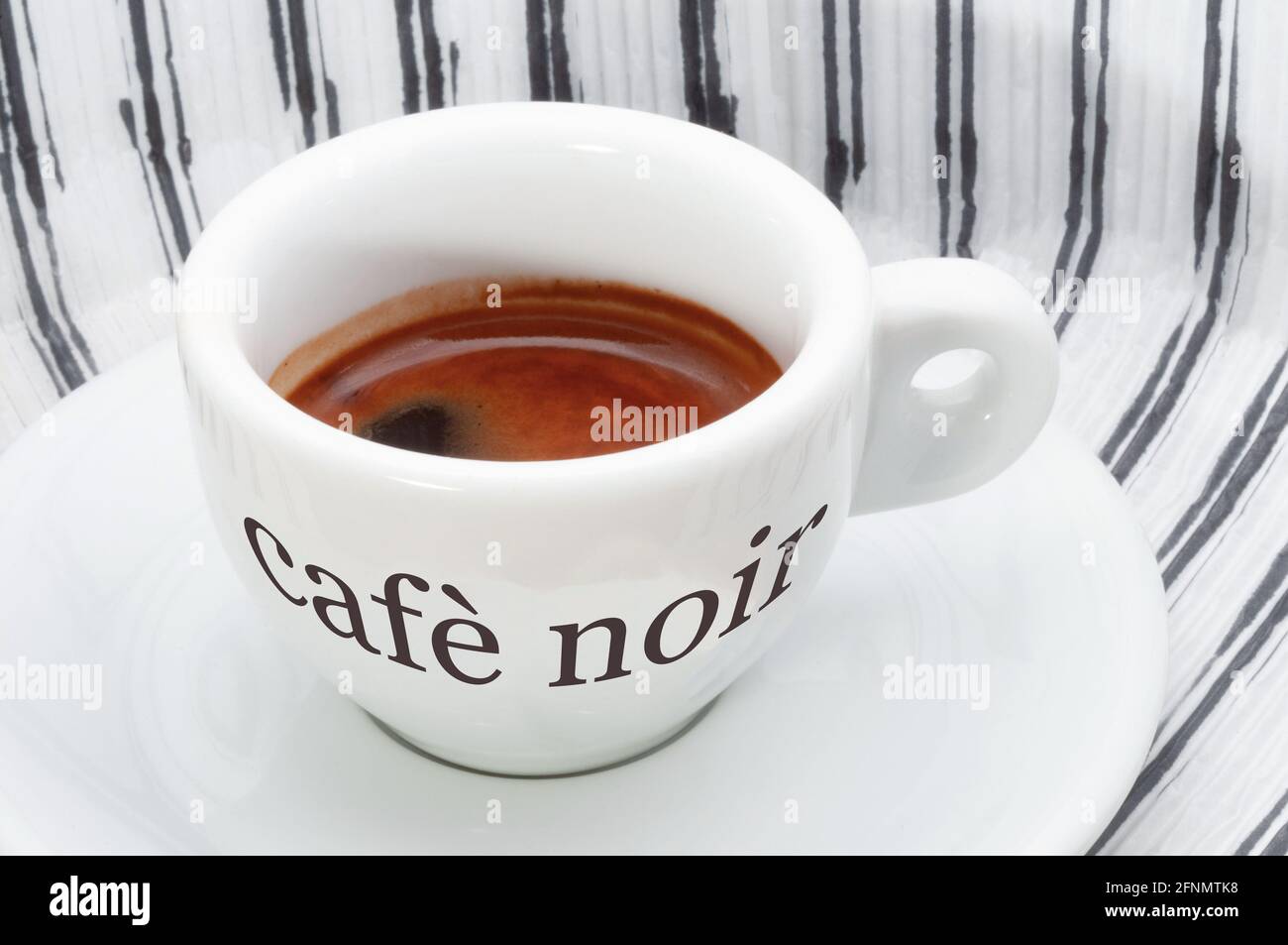 Cafè noir logo on a coffee cup with striped background Stock Photo - Alamy