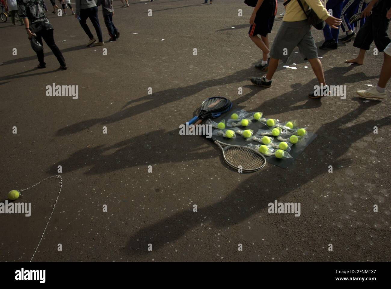People walking as a recreational sport, passing tennis rackets and tennis  balls laid on the ground outside Senayan Main Stadium (Gelora Bung Karno  Stadium) in Jakarta, Indonesia Stock Photo - Alamy