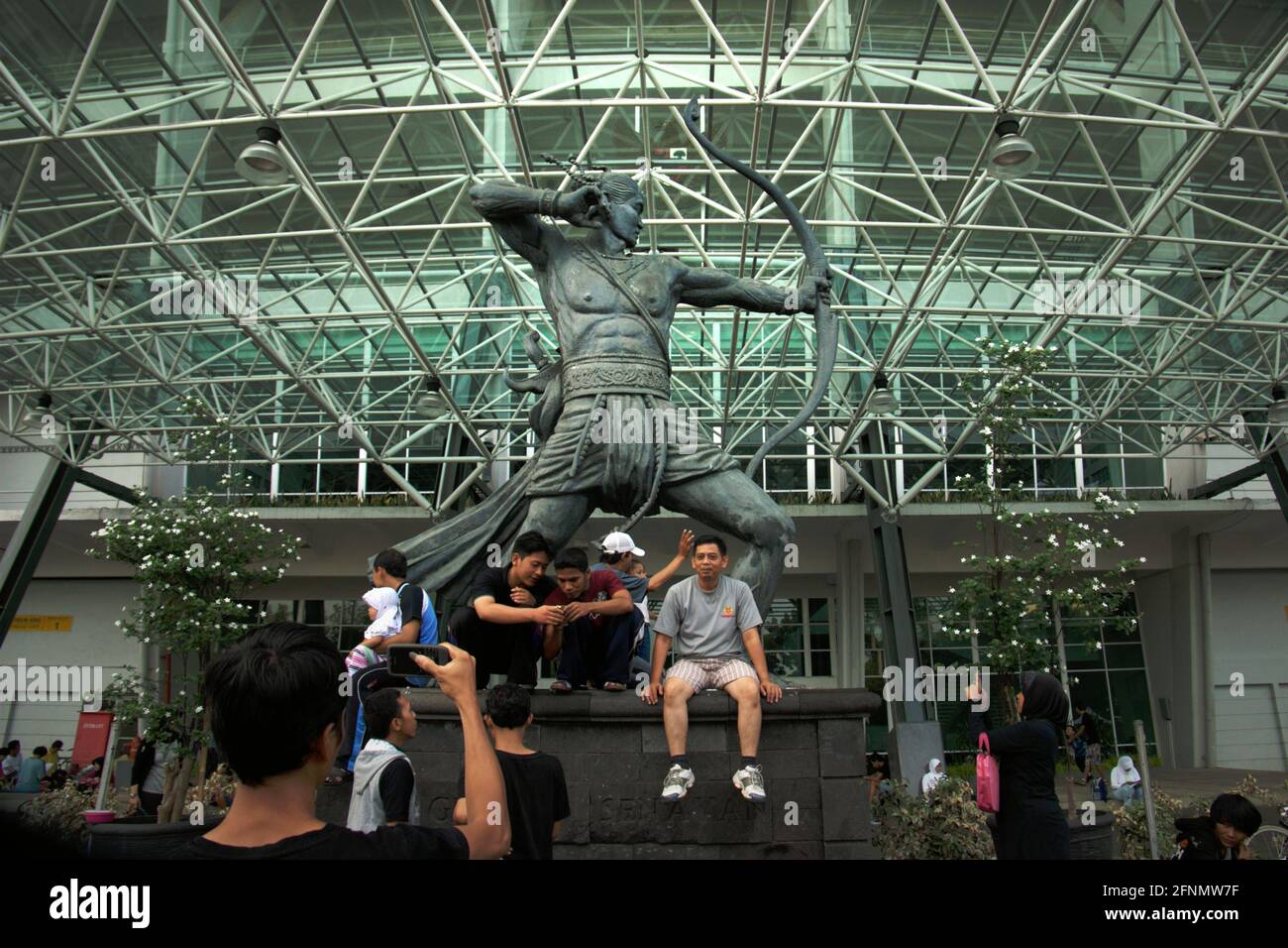 People having recreational time after sport activity outside Senayan Main Stadium (Gelora Bung Karno Stadium) in Jakarta, Indonesia. Stock Photo