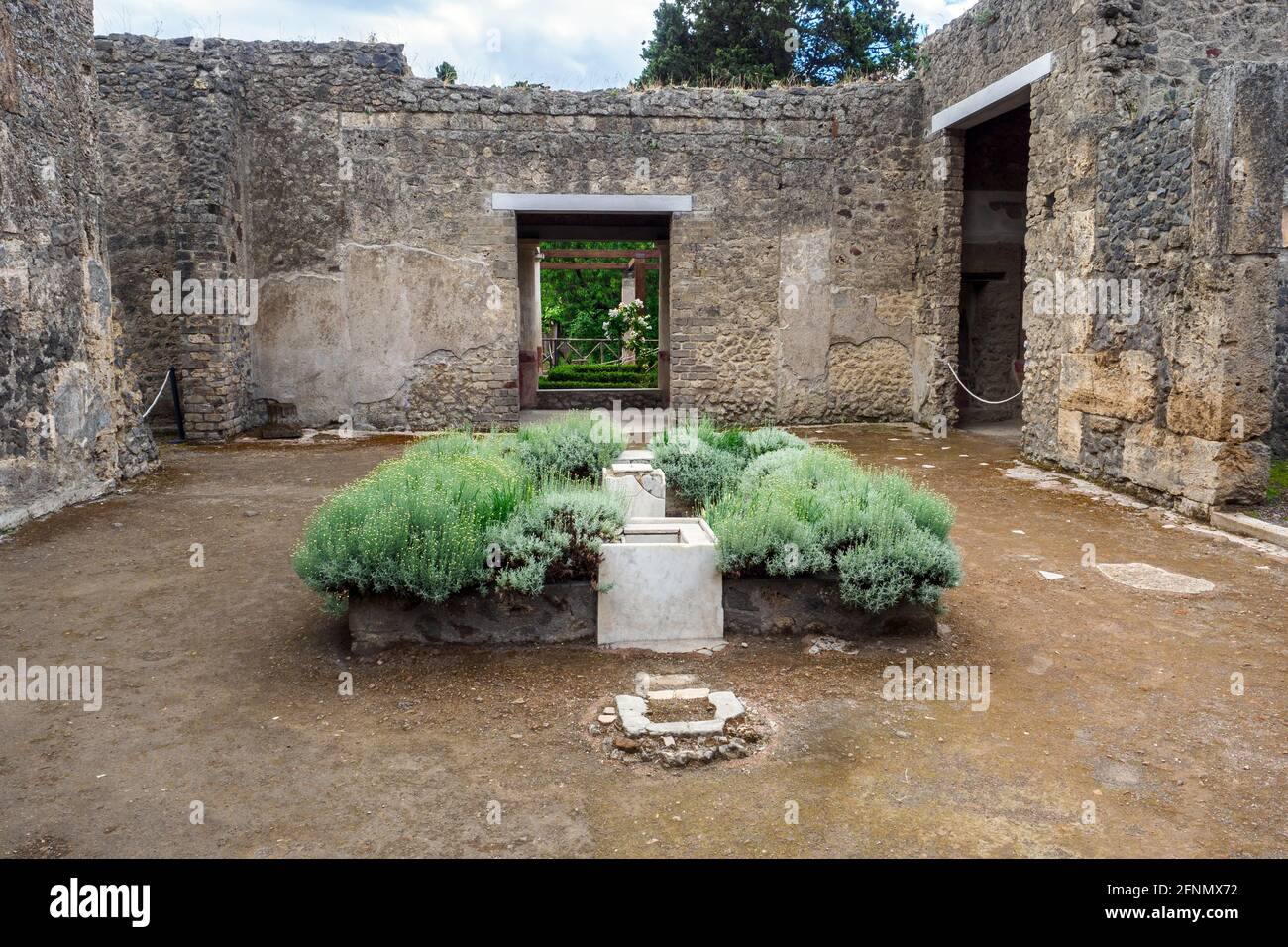 Rectangular atrium with a central impluvium surrounded by a border for plants in the House of Octavius Quartio - Pompeii archaeological site, Italy Stock Photo