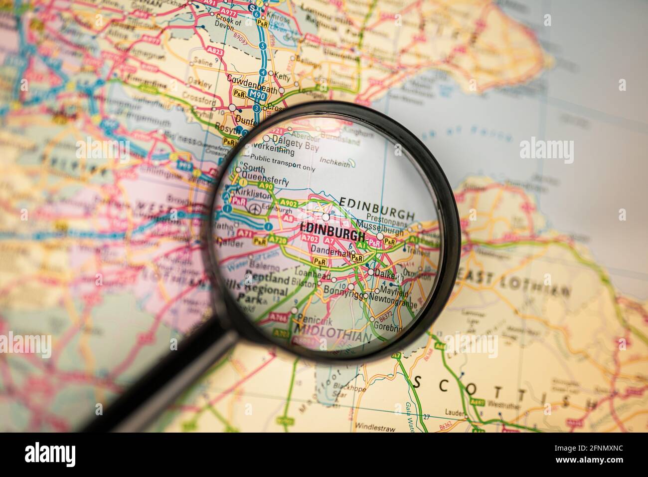 Close-up map of Edinburgh through black magnifying glass, capital of Scotland, city in the United Kingdom Stock Photo
