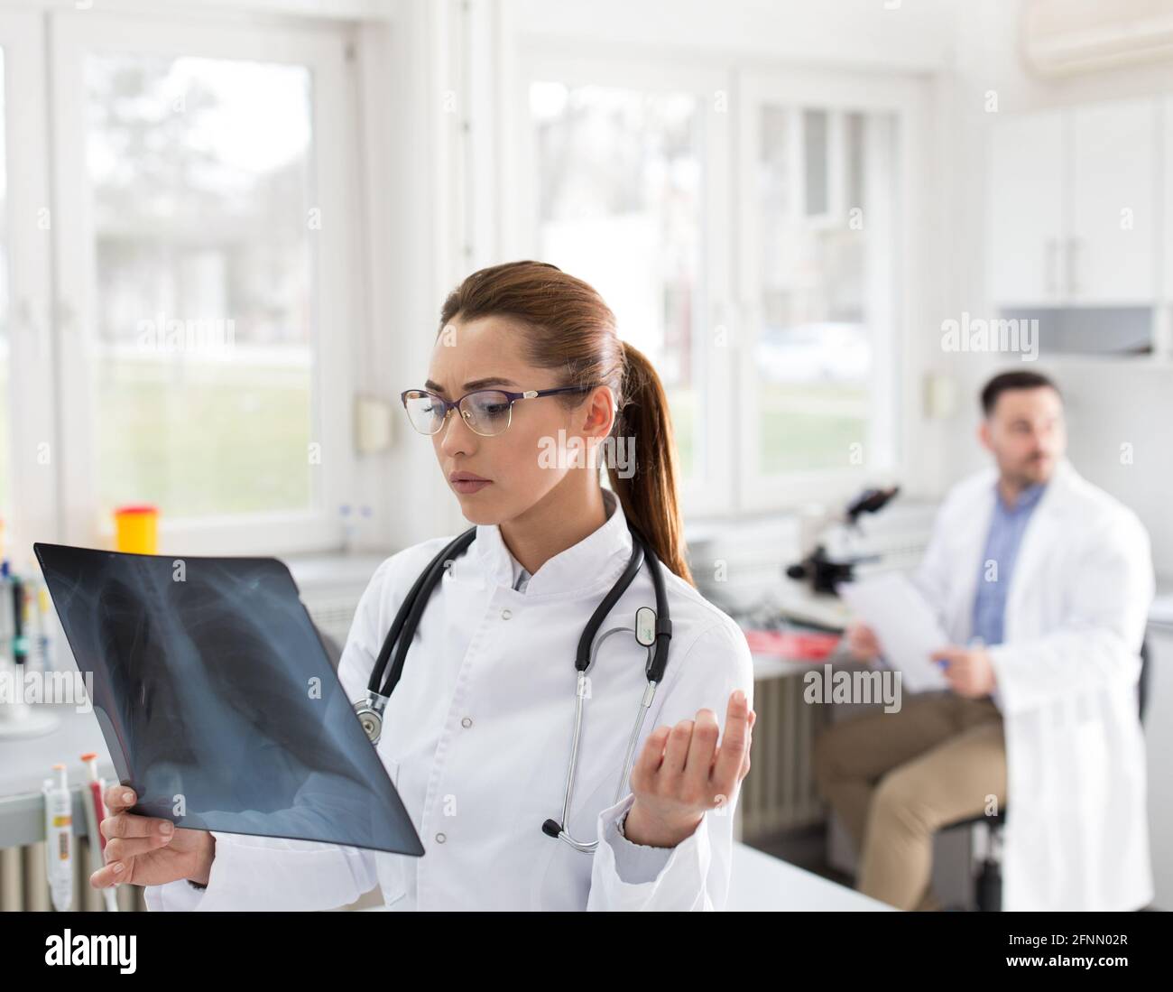 Female doctor looking at x ray at laboratory Stock Photo