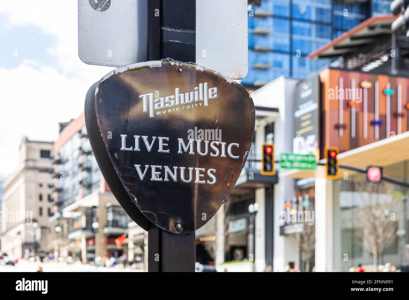 A sign shaped like a guitar pick advertising the live music venues in downtown Nashville. Stock Photo