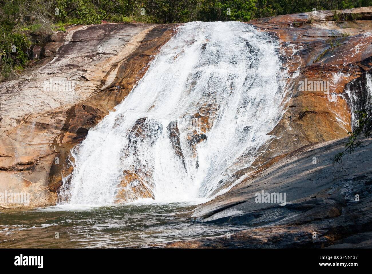 Small waterfall over colored rocks near Debegeni Falls, Limpopo, South Africa Stock Photo
