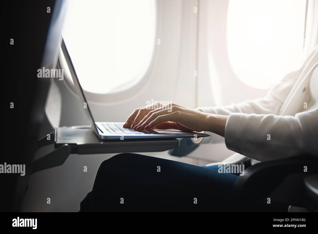 Using the flight time productively and working Stock Photo
