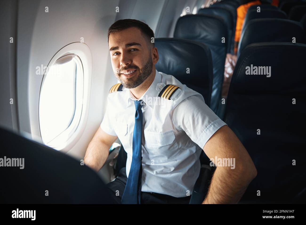 Satisfied pilot after checking the airplane cabin Stock Photo