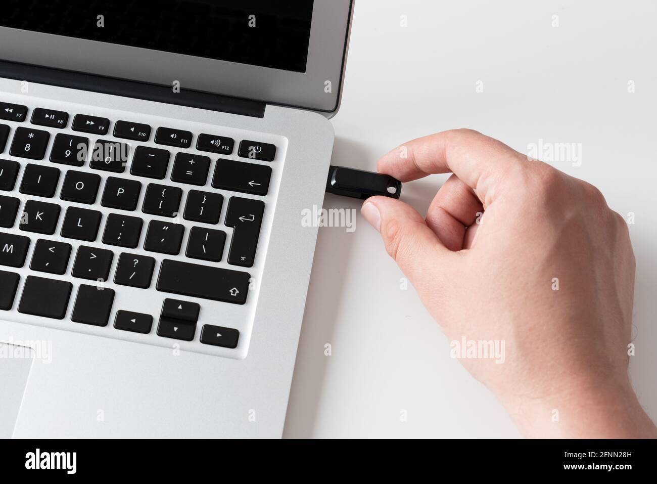 Hand connecting USB flash drive. Pendrive, flash memory concept Stock Photo