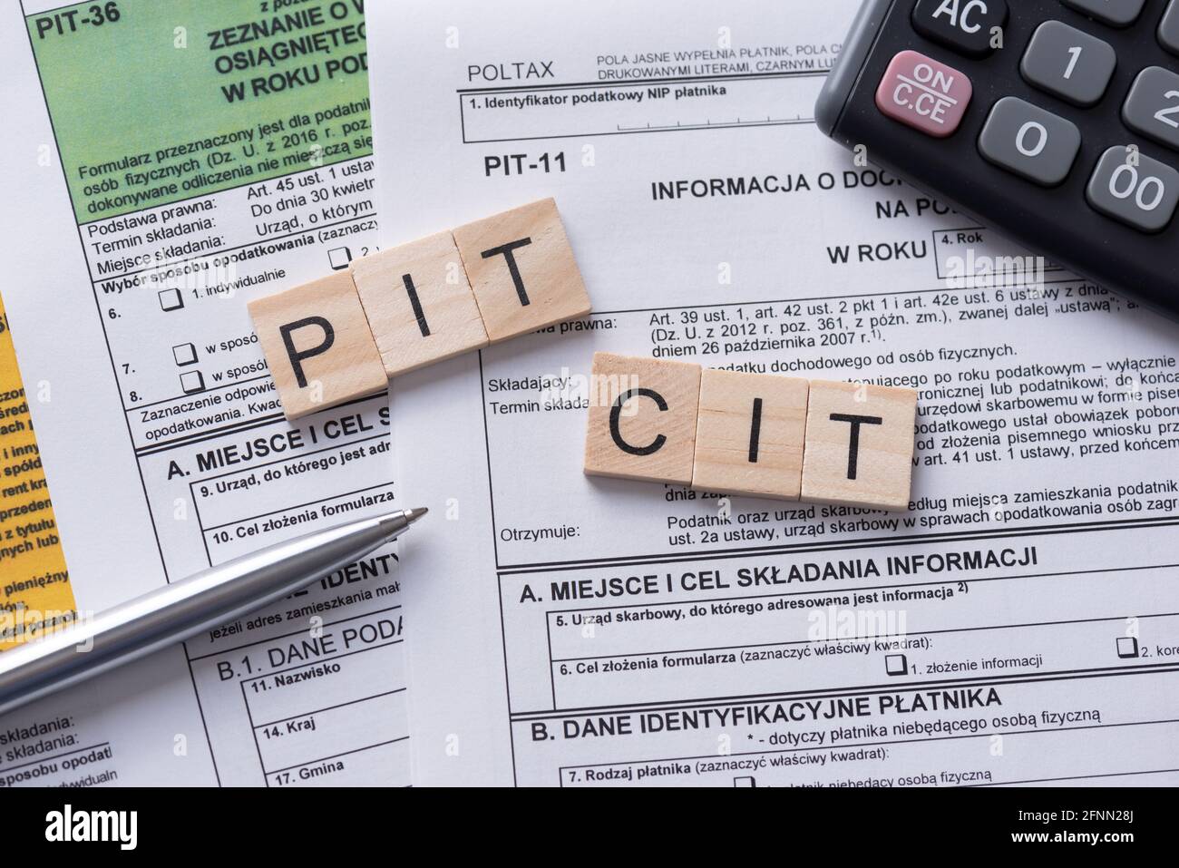 Tax income concept with polish tax forms and PIT, CIT words from tiles, means personal and company tax income in Poland Stock Photo