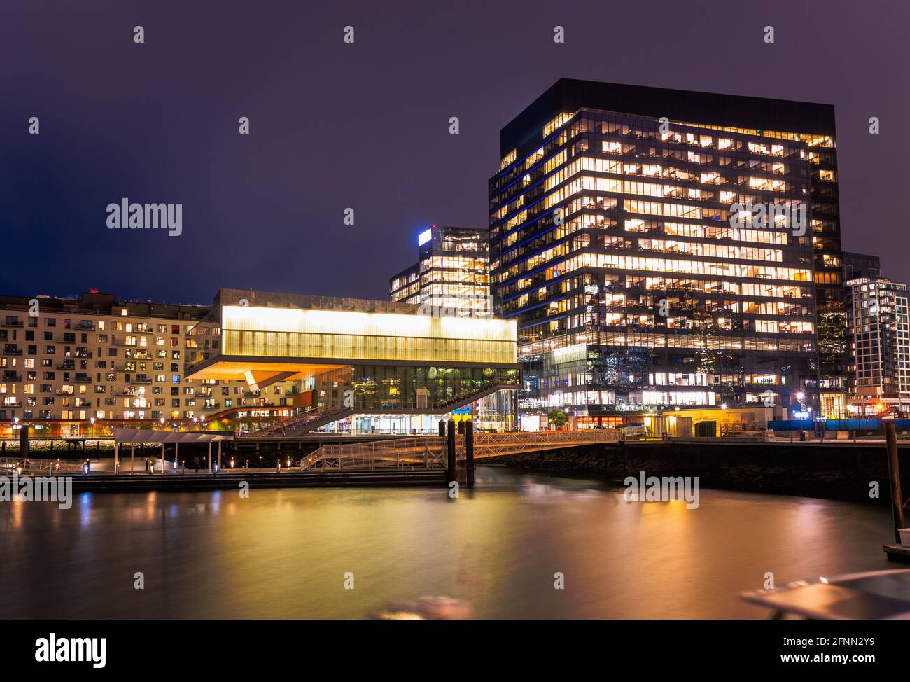 Modern waterfront office and apartment buildings at night Stock Photo