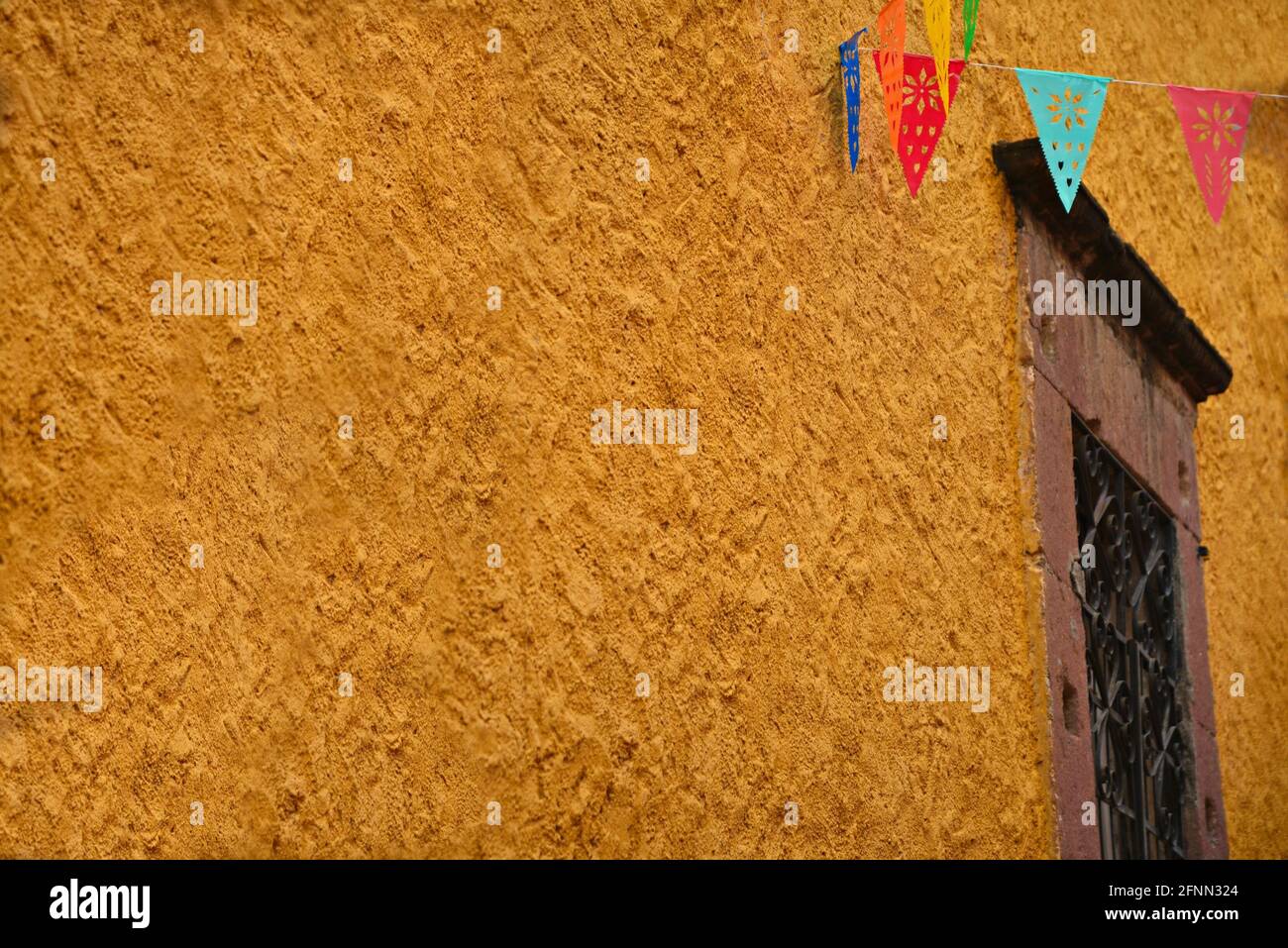 Old Colonial building ochre wall with a stone trimmed window and ...