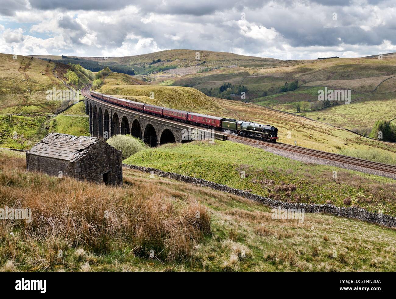 Dentdale, Yorkshire Dales National Park, UK. 18th May, 2021. 'The Pendle Dalesman' crosses Arten Gill Viaduct in Dentdale in The Yorkshire Dales National Park. This is the first steam special train of the year / post-pandemic lockdown on the famous Settle-Carlisle railway line. The train, operated by West Coast Railways, is locomotive 35018 'British India Line', originally built in the 1940s. The train ran from Lancaster to Carlisle. Credit: John Bentley/Alamy Live News Stock Photo