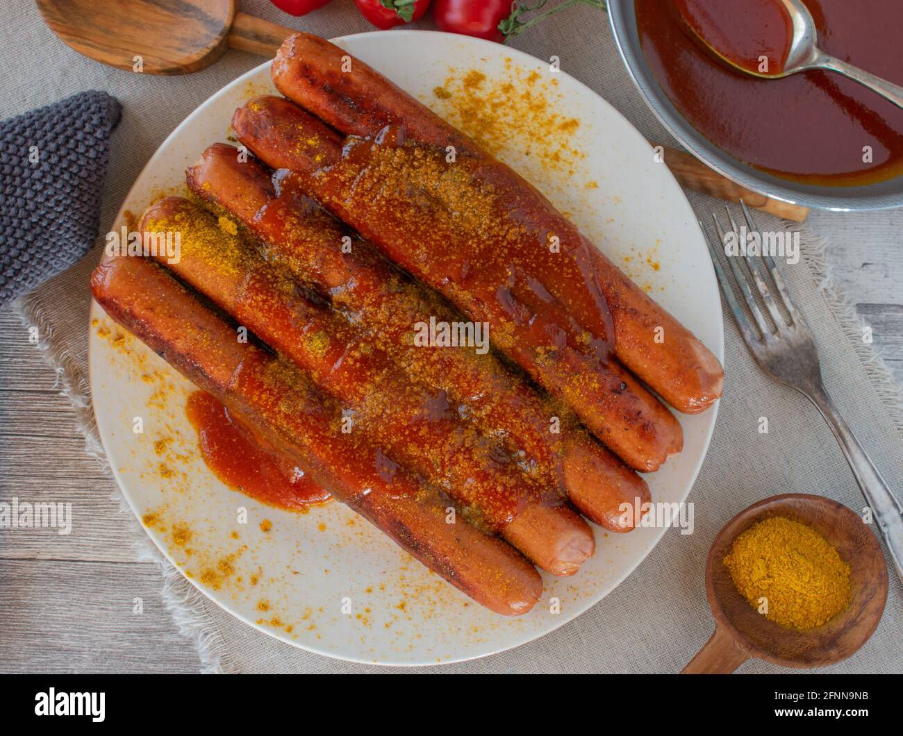 fried sausages with delicious fruity tomato curry sauce Stock Photo Alamy