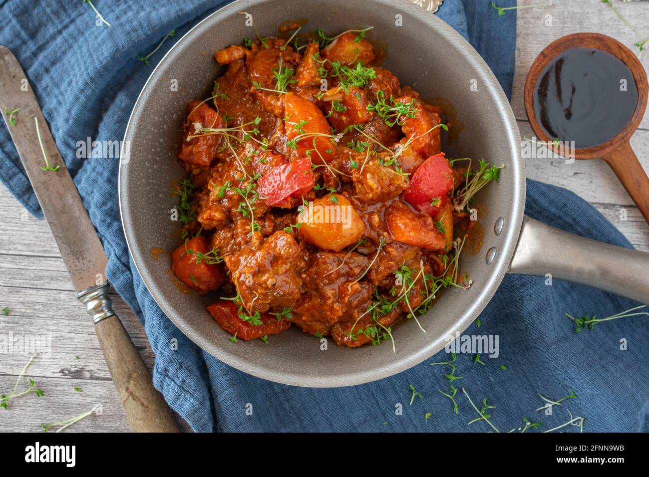 filipino spicy Pork stew afritada with vegetables served in bowl. Overhead view Stock Photo