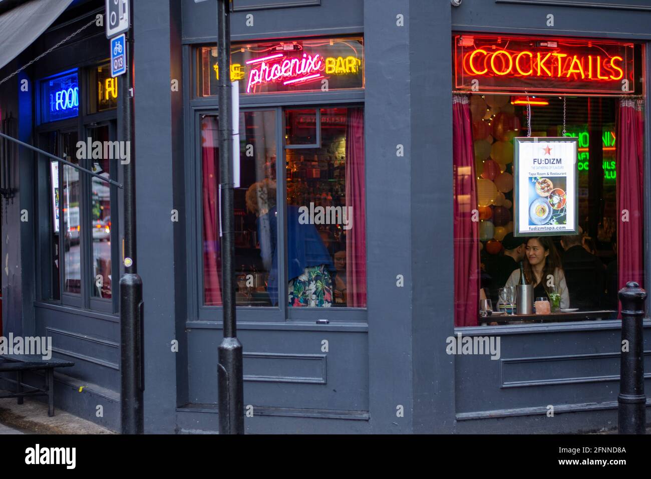 People indoor dinning at a restaurant in Shoreditch, London.From May 17, venues are allowed to offer indoor dining for groups of six people or two households as part of Step Three of the government's 'roadmap' out of lockdown. Stock Photo
