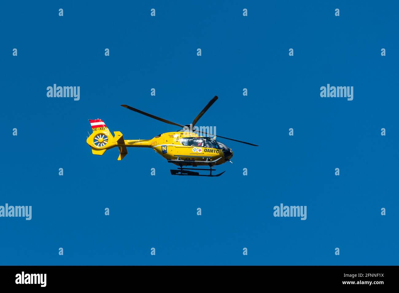 Vienna, Austria 31 March 2021: An Austrian ambulance helicopter flying, blue sky Stock Photo