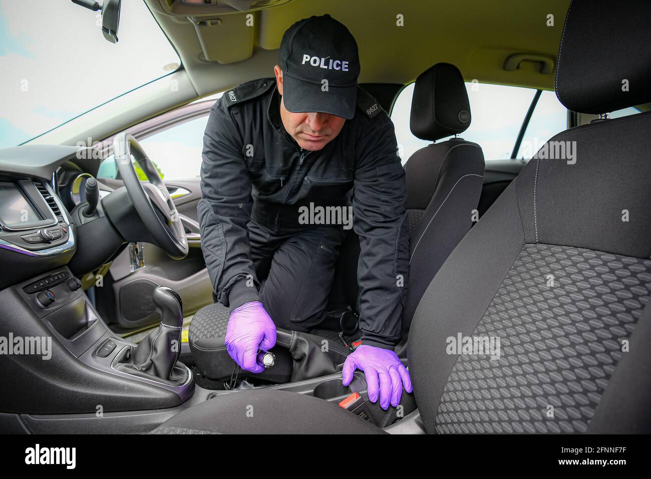 Police search teams inspect the interior of a car as they demonstrate policing procedures ahead of the forthcoming G7 Summit in Cornwall at Devon And Cornwall Police Headquarters, Exeter. Stock Photo