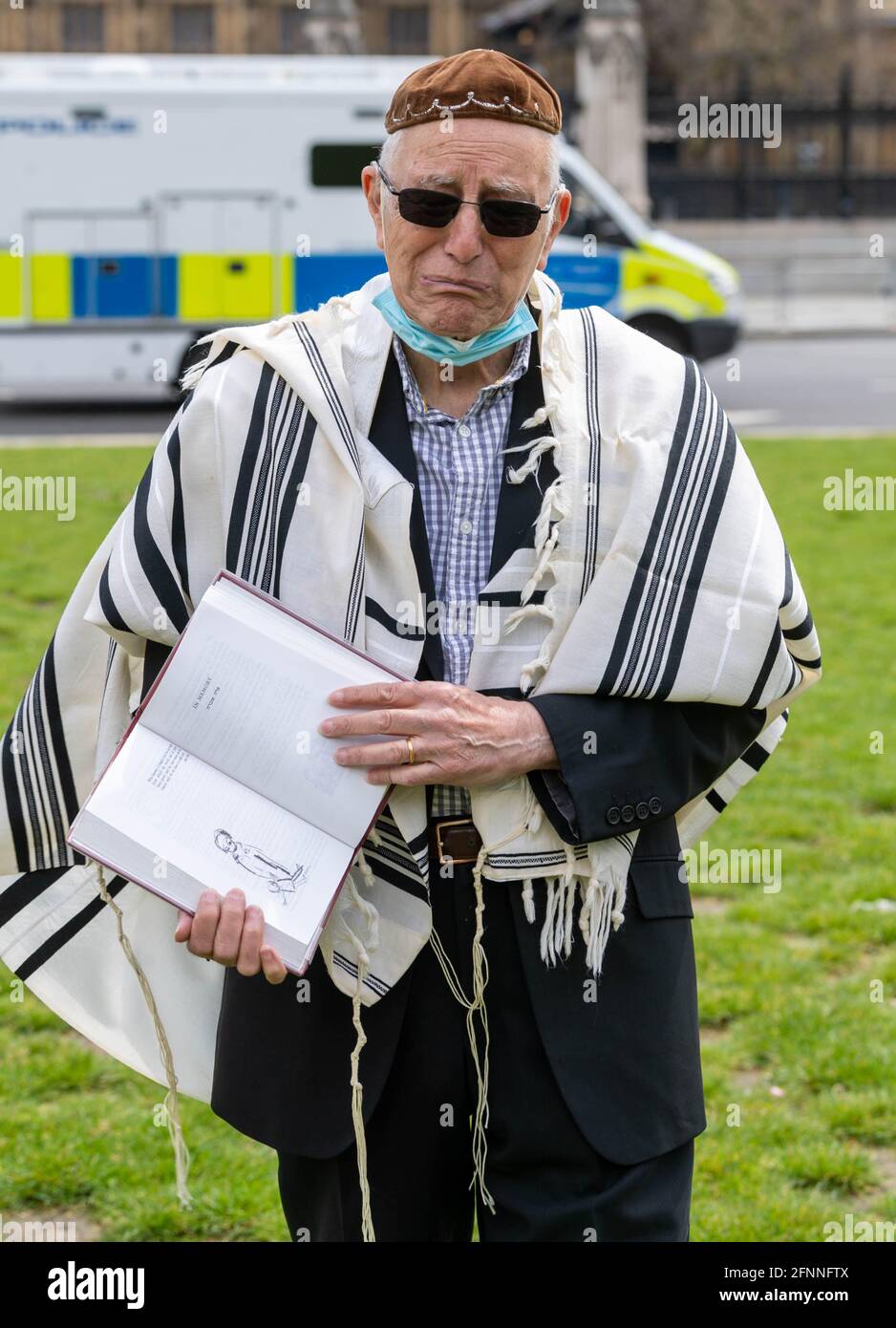 London, UK. 18th May, 2021. Rabbi Jeffery Newman praying outside the House of Commons for an end of the occupation of Paslestine, for the British Government to recognise Palestine and to support the Peoples initiative for Peace. Rabbi Newman is calling for 50% plus 1 British MP's to sign a statement of agreement to his demands. The Rabbi is planning to pray outside Parliment for several days. Credit: Ian Davidson/Alamy Live News Stock Photo