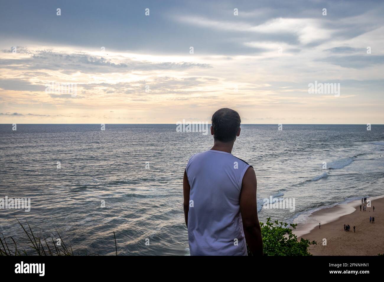 Isolated man watching beautiful sunset over sea horizon Stock Photo - Alamy