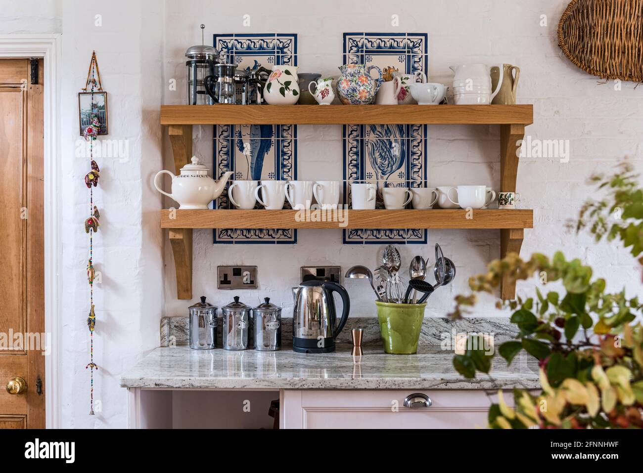 Collection of chinaware in kitchen of 19th century Victorian cottage. Stock Photo