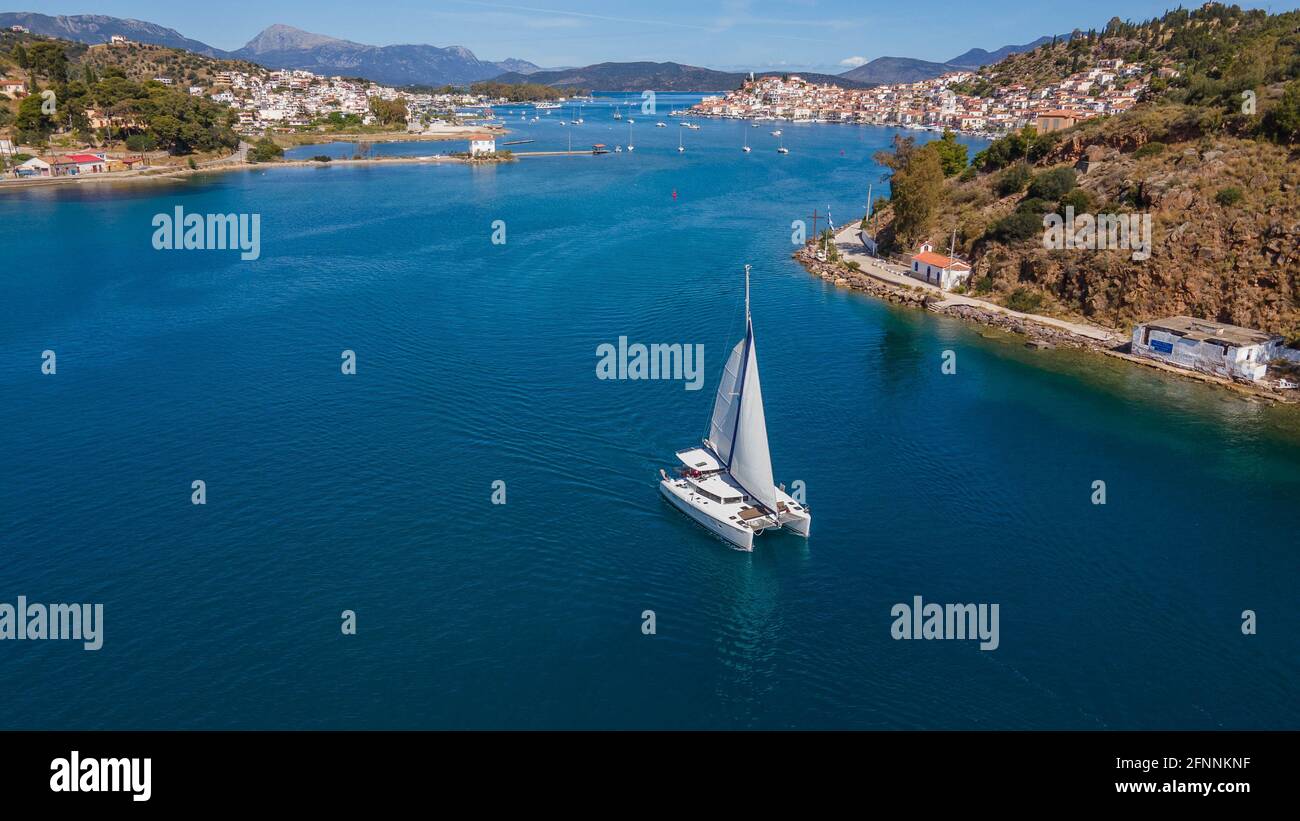 Catamaran sailboat getting out the Poros canal,Greece Stock Photo