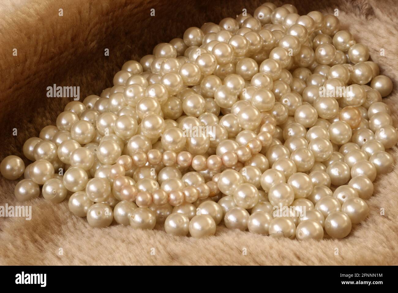 White pearls on fur background Stock Photo