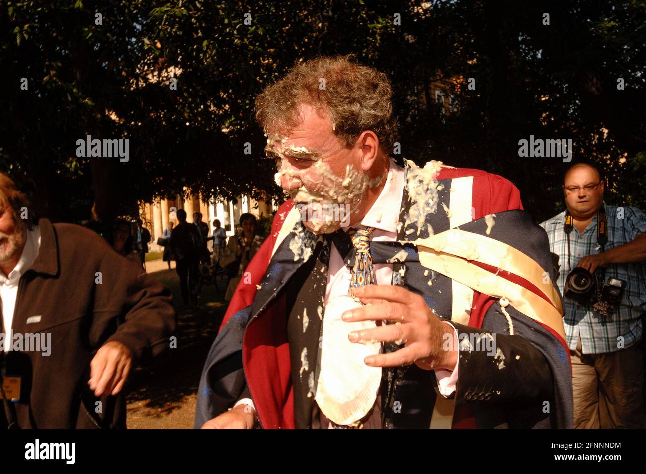 Jeremy Clarkson, being hit with a pie thrown by environmental protester who was protesting against Clarkson views about manmade climate change. Jeremy Clarkson just received a honorary degree from Oxford Brookes University.  Oxford Brooks University, Oxford, UK.  12 Sep 2005 Stock Photo